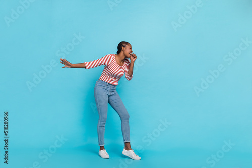 Fototapeta Naklejka Na Ścianę i Meble -  Full length photo of excited crazy girl enjoy partying singing hand isolated on blue color background