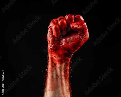 Bloody male fist on a black background. © Михаил Решетников