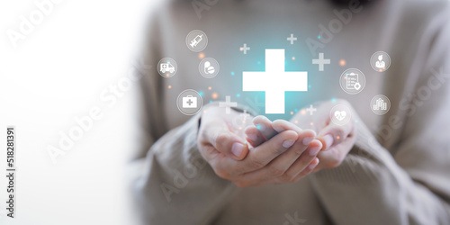 Woman hand holding plus icon for the healthcare medical icon. Health insurance health concept. access to welfare health and copy space, photo