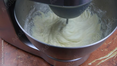 Kneading dough in the modern kitchen machine on a table