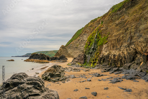 Beach waterfall and rock formations at Tresaith Ceredigion West Wales United Kingdom