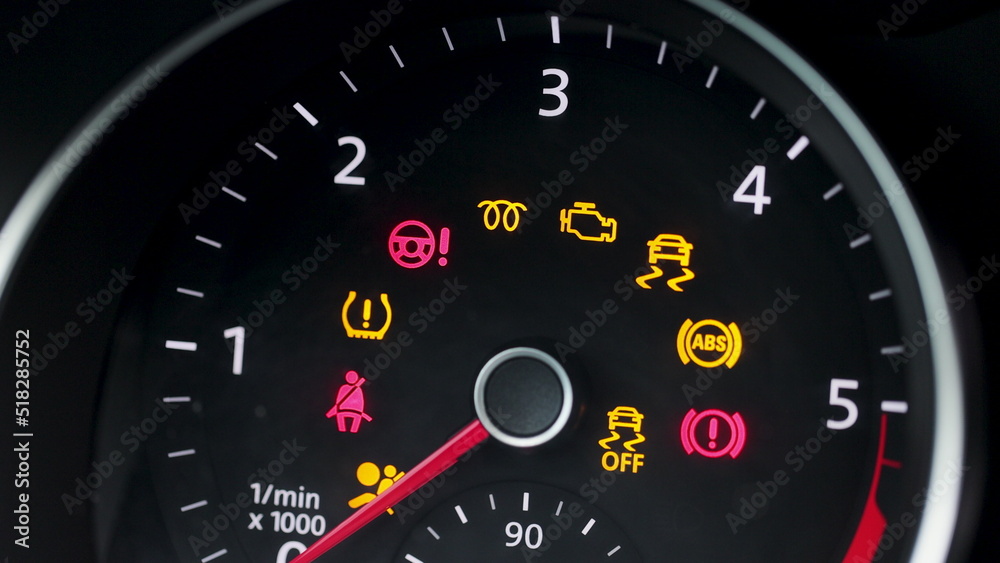 Many different car dashboard lights with warning lamps illuminated. Light symbol that pops up on dashboard when something goes wrong with the engine