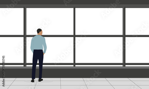 A male character in business clothes stands and looks out the big window