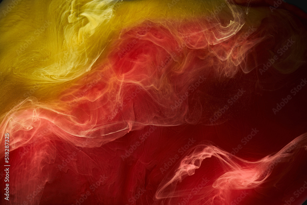 Fototapeta premium Liquid fluid art abstract background. Red, yellow dancing acrylic paints underwater, space smoke ocean, color explosion