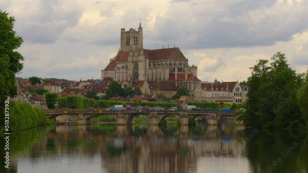 Time lapse. Beautiful clouds in the background of the old city. View of city landscape of Auxerre with Cathedral of Saint-Etienne on River Yonne, Burgundy, France Time lapse. Beautiful clouds in the background of the old city. View of city landscape of Auxerre with Cathedral of Saint-Etienne on River Yonne, Burgundy, France