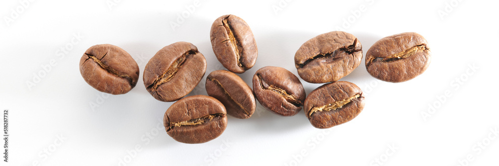 Roasted coffee beans isolated close up on white background, clipping path Roasted coffee beans isolated close up on white background, clipping path