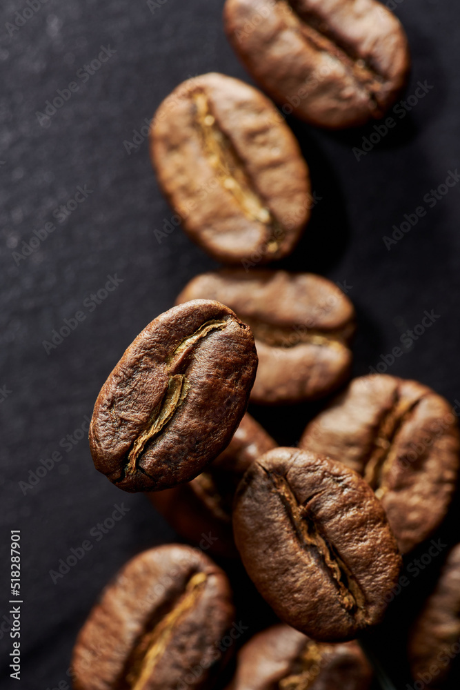 Fototapeta premium Roasted coffee beans isolated close up on black background, clipping path