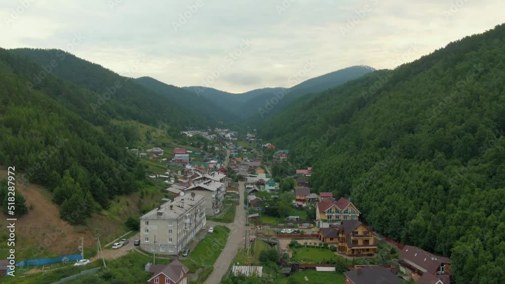 Flight over the village between the forest hills. Dolly zoom. Human and nature. Green mountains. Aerial drone footage. Flight over the village between the forest hills. Dolly zoom. Human and nature. Green mountains. Aerial drone footage.