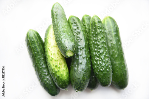 Green juicy cucumbers on a white background.