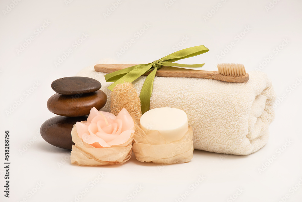 Spa treatment with zen stones,soap,candle isolated on white background. Spa treatment with zen stones,soap,candle isolated on white background.