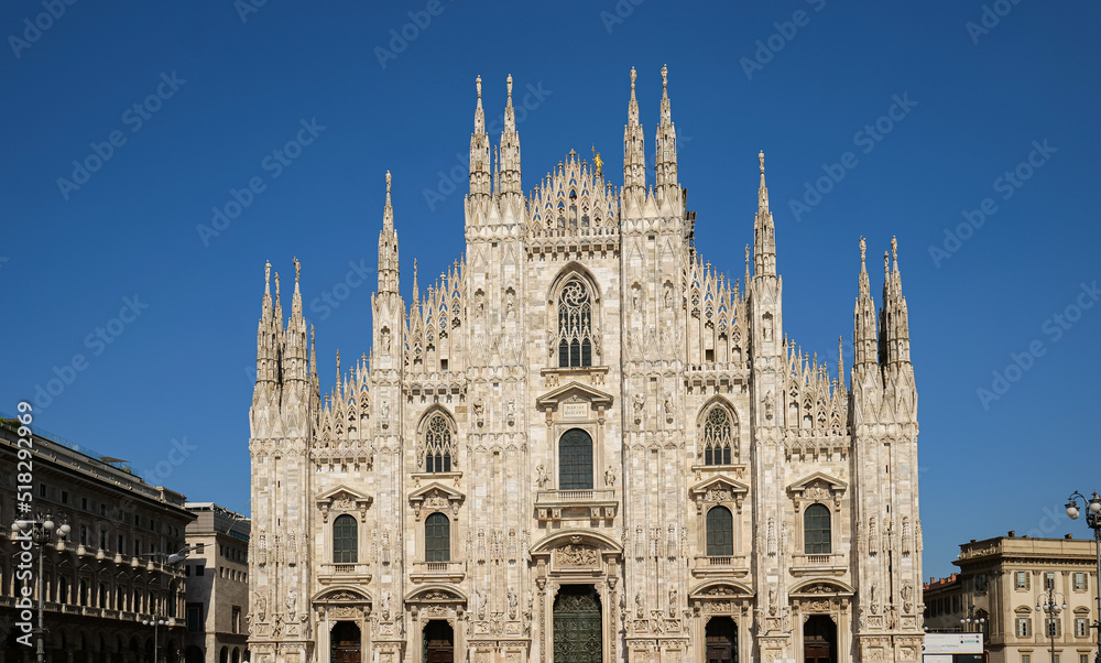 Wide angle view of the amazing architecture landmark Milan Cathedral (Italian Duomo di Milano) in a beautiful sunny day with blue sky. Travel to Italy.