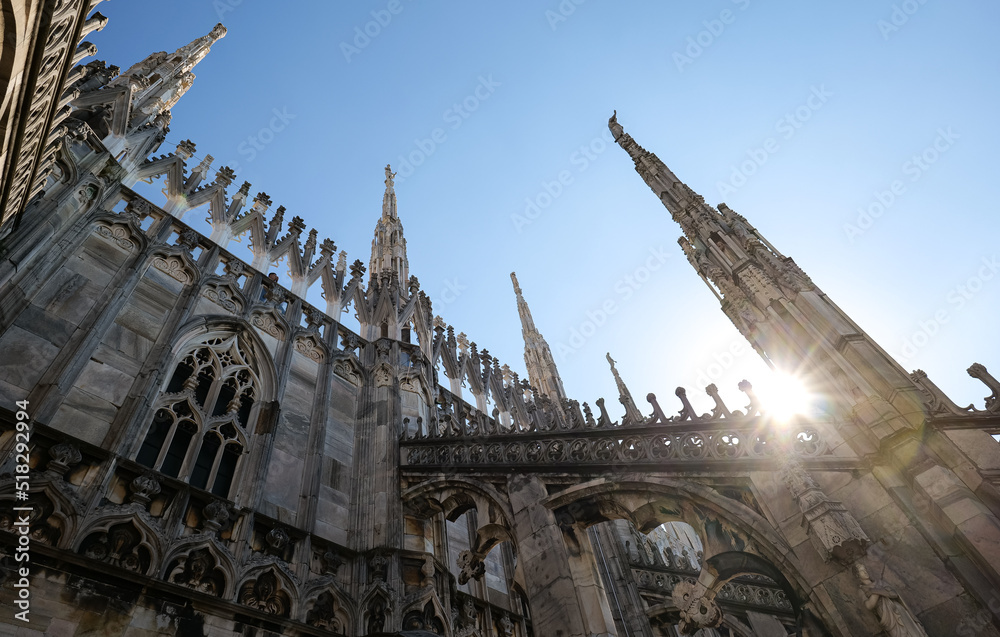 Architecture details from the rooftop of Milan Cathedral (Italian Duomo di Milano) in a blue sky sunny day. Travel landmarks of Italy.