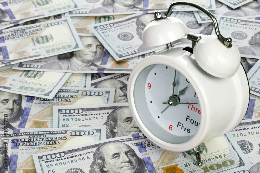 Time is money concept with clock and USA dollars Time is money concept with clock and USA dollars