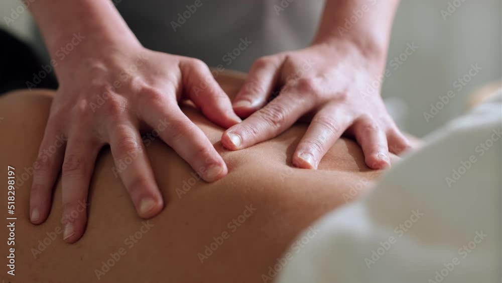 Video of close up of female physiotherapist doing a back treatment to the patient in a physiotherapy room. Rehabilitation, medical massage and manual therapy concept.