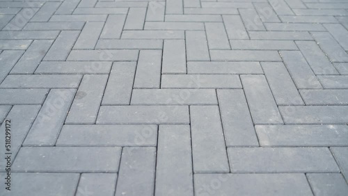 Trowel for laying floor tiles. Alignment of sand mortar on paving stones. Fine sand is poured into the cracks of paving slabs. photo