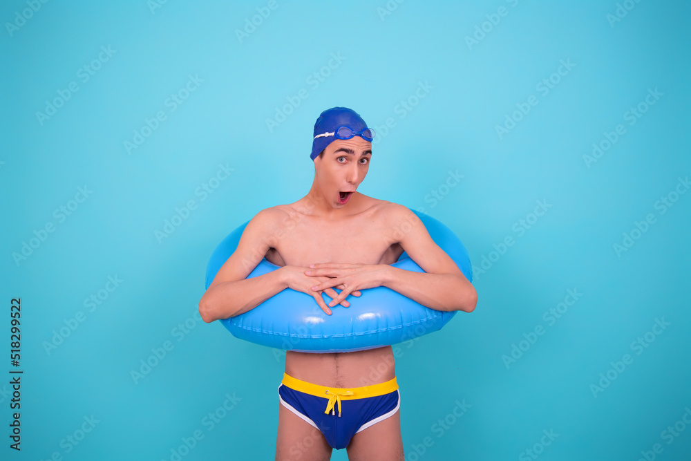 Funny guy with an inflatable ring in the pool.	