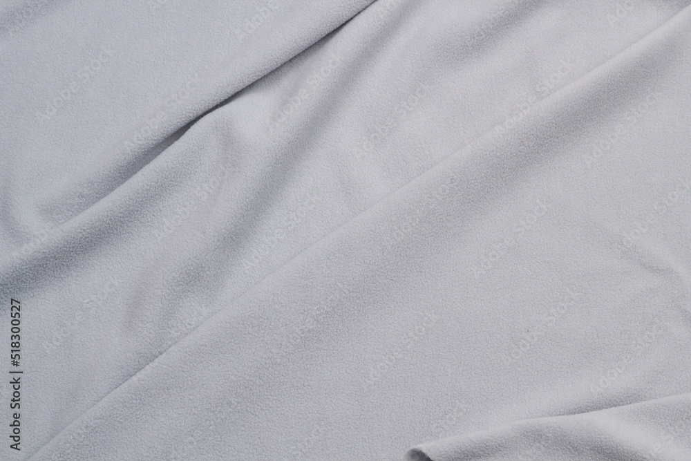 Fototapeta premium Fleece fabric blue top view. Texture of textile fleece bedspread. 