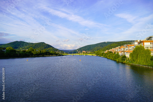 View of the Neckar and Heidelberg from the Wehrsteg Wieblingen. Weir on the Neckar. Pedestrian and bike path. 