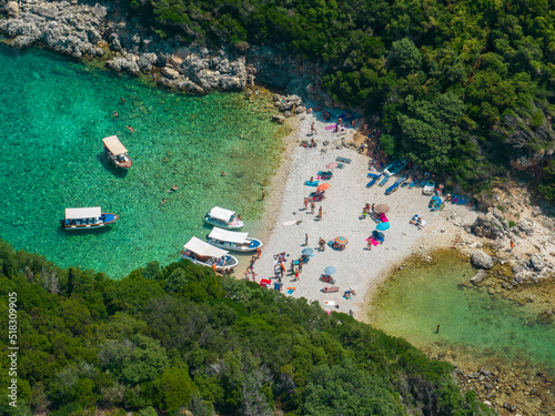 Aerial view of Limni Beach Glyko, on the island of Corfu. Greece. Where the two beaches are connected to the mainland providing a wonderful scenery. Unique double beach. Bathers and boats photo