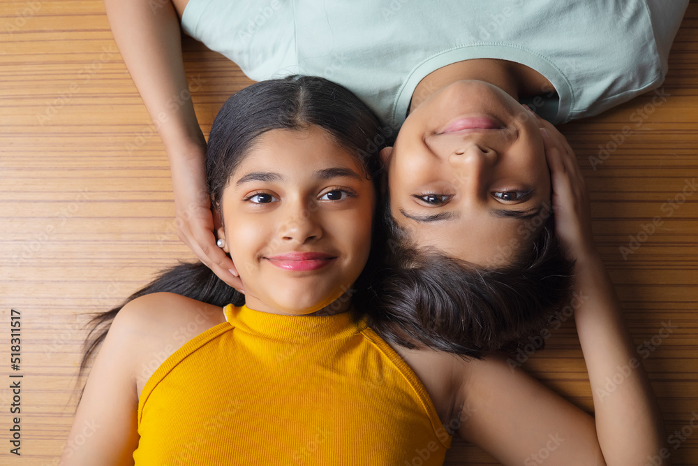 Close-up of boy and girl lying down on wooden floor Close-up of boy and girl lying down on wooden floor