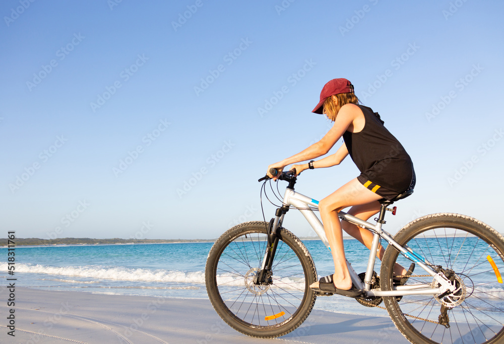 Kid riding bike along seashore