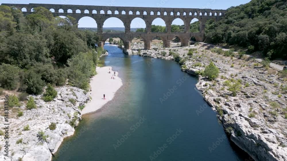 Drone approaching The Pont du Gard, an ancient Roman aqueduct bridge in France