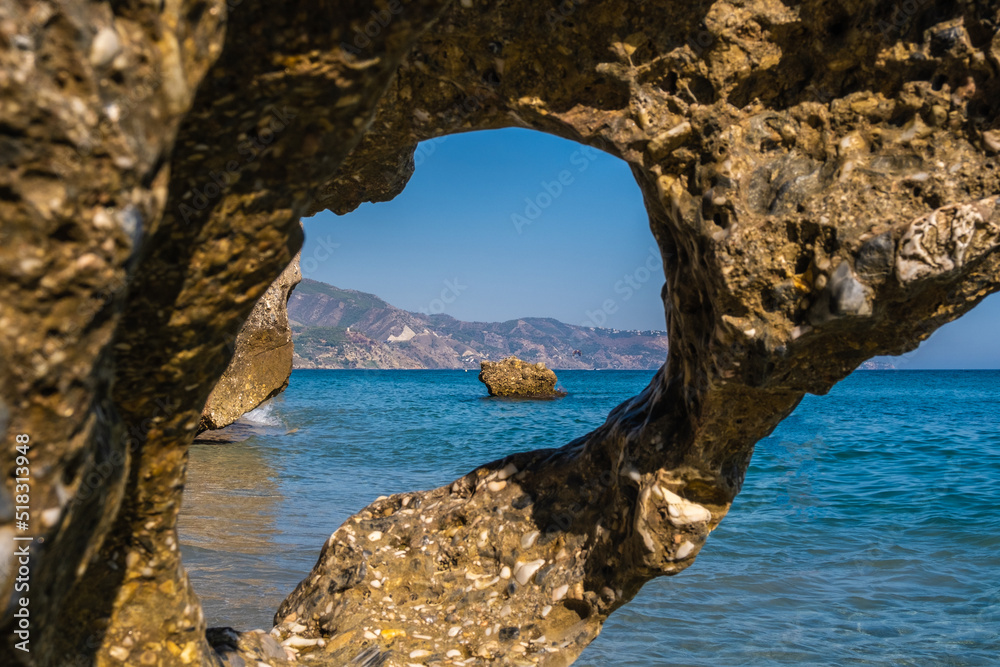 Beautiful view of the Mediterranean sea through rock formations at Nerja beach
