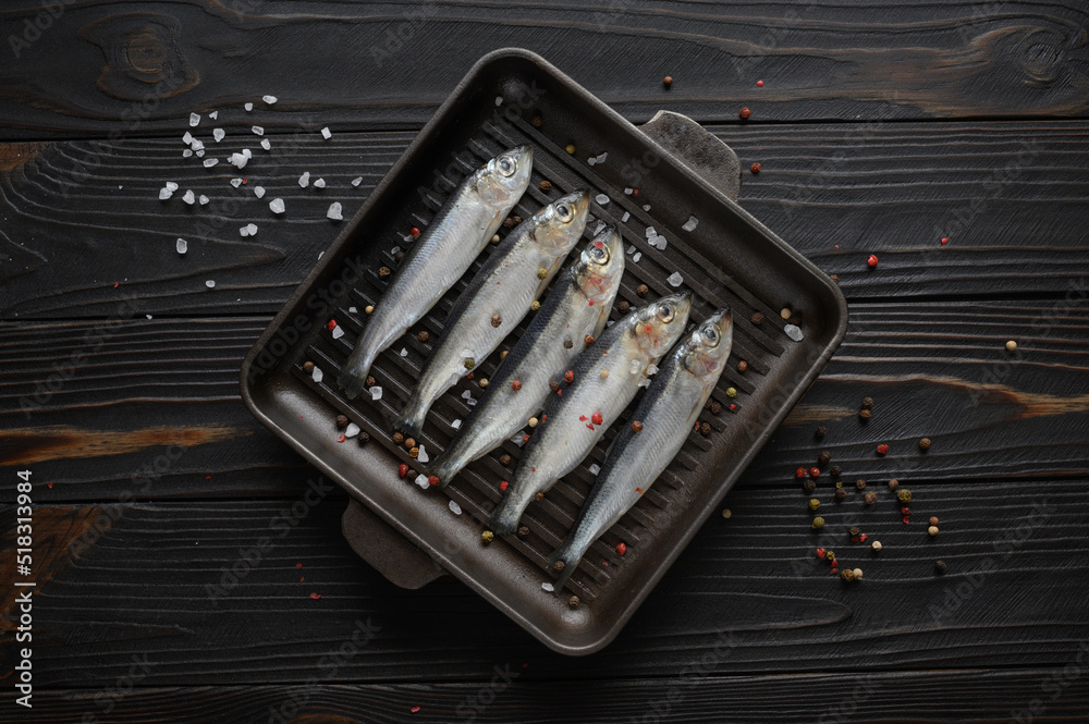 Fresh herring on rustic wooden background, close up shot Fresh herring on rustic wooden background, close up shot