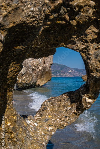 Beautiful view of the Mediterranean sea through rock formations at Nerja beach