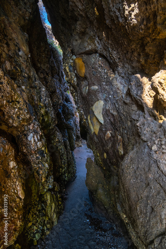 Beautiful view of secret path between rocks in Nerja beach, Spain
