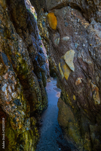 Beautiful view of secret path between rocks in Nerja beach, Spain