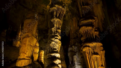 A tilt up shot of a cave with stalagmites and stalactites in Luray Cavern under a mountain in Shenandoah Valley photo