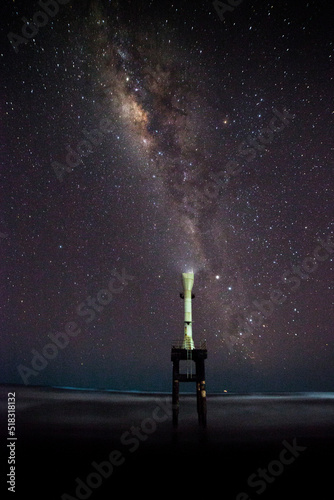 Milky way over the Apra Beach lighthouse, Indonesia