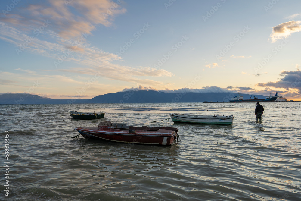 Naklejka premium Sunset Over the Sea with Fishing Boat , Beautiful Nature Background from Vlore, Albania