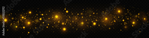 Golden shimmering background with light effect. The dust sparks and golden stars shine with special light on a transparent background. Christmas concept.