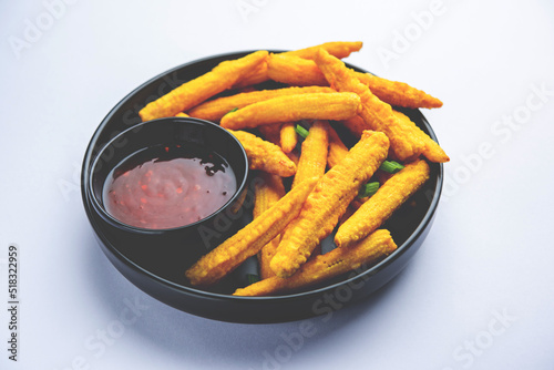 Crispy fried baby corn pakoda, pakora  or Baby corn fritters served with ketchup, Indian food photo