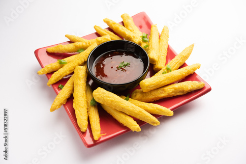 Crispy fried baby corn pakoda, pakora  or Baby corn fritters served with ketchup, Indian food photo