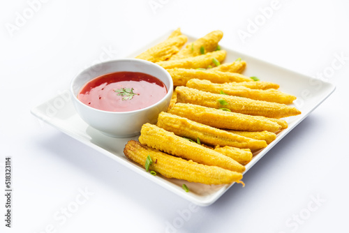 Crispy fried baby corn pakoda, pakora  or Baby corn fritters served with ketchup, Indian food photo