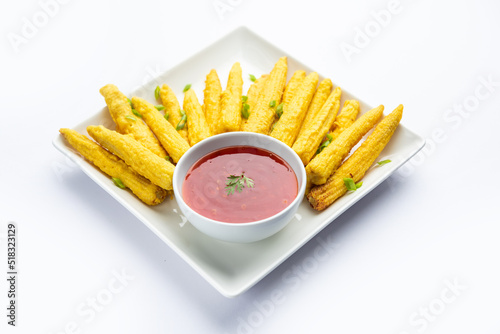 Crispy fried baby corn pakoda, pakora  or Baby corn fritters served with ketchup, Indian food photo