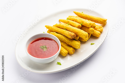 Crispy fried baby corn pakoda, pakora  or Baby corn fritters served with ketchup, Indian food photo