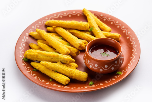 Crispy fried baby corn pakoda, pakora  or Baby corn fritters served with ketchup, Indian food photo