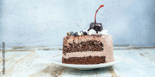 Slice of tasty homemade choccolate cake on the plate on wooden background photo