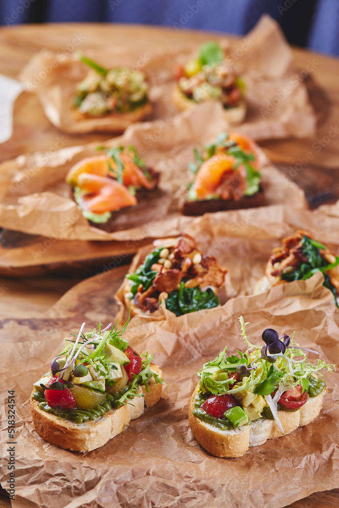 Assorted bruschettas with various fillings. Appetizing bruschetta. Variety of small sandwiches or crostini. Traditional italian appetizer or snack, antipasto
