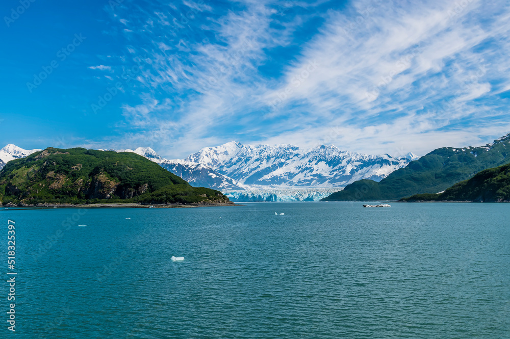 A view past Haenke Island towards the Hubbard glacier in Disenchartment Bay in Alaska in summertime