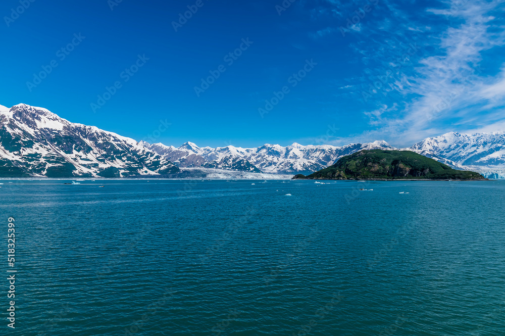 A view past Haenke Island towards the glaciers of Disenchartment Bay in Alaska in summertime