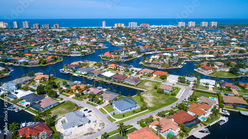 Aerial View Showing the Waterways in Marco Island, Florida with the Gulf of Mexico in the Distance with the Beach and Real Estate