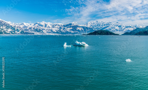A view across Disenchartment Bay past icebergs towards the Valerie Glacier in Alaska in summertime