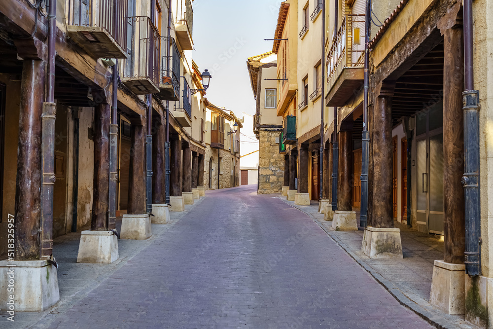 Main street with medieval arcades made of wooden columns in San Estaban de Gormaz, Soria.
