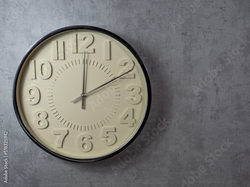 Wall clock on a gray background. Clock close up.