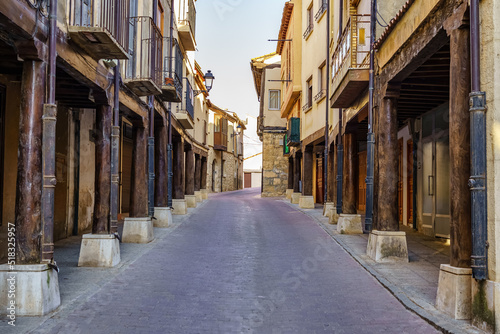 Main street with medieval arcades made of wooden columns in San Estaban de Gormaz, Soria.